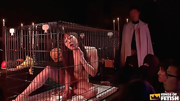 Japanese babe in cage eats and pisses in front of more guys