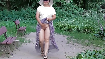 Wife in transparent dress in public park