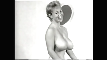 Nude model with a gorgeous figure takes part in a porn photo shoot of the 50s